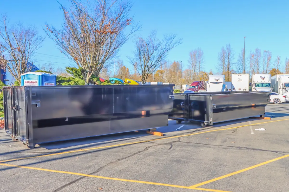 Professional dumpster rental service with roll-off container on residential driveway in Coatesville